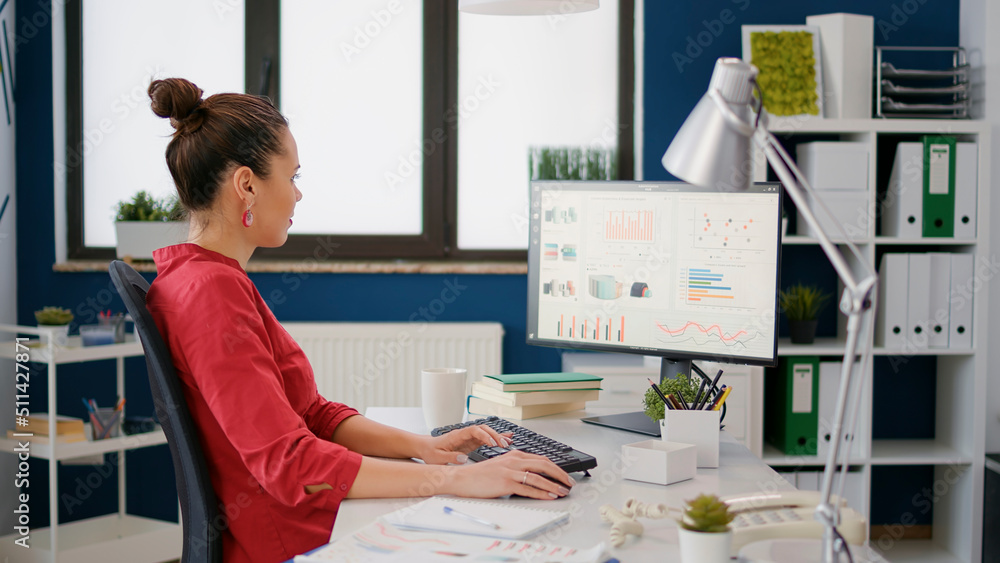 Poster company accountant working with sales analysis on computer, using data charts for business growth. f
