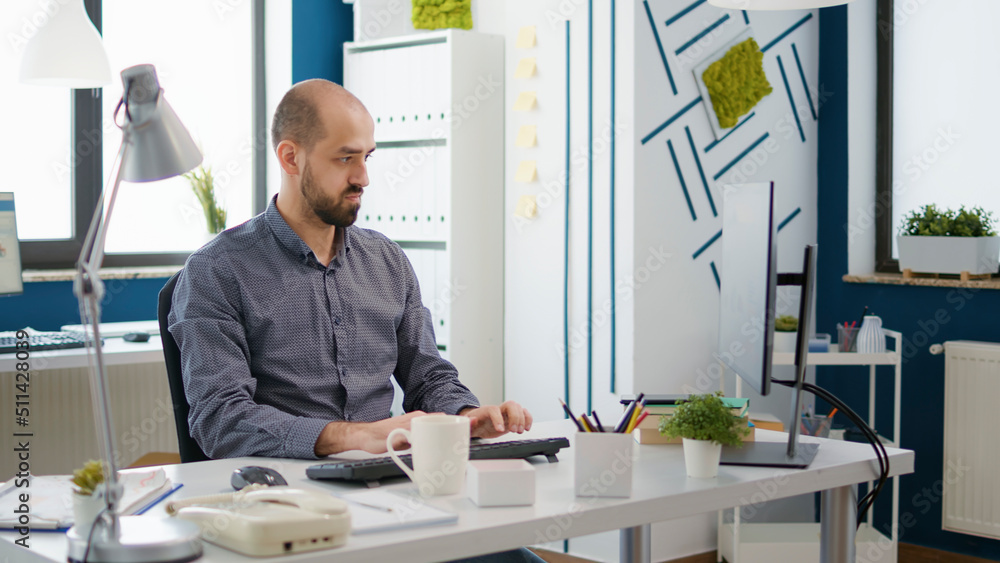 Poster business man working on financial startegy and checking text message on smartphone, using computer t