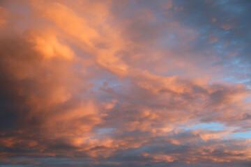 Naklejka na ściany i meble blue sky and many clouds with orange and pink colors