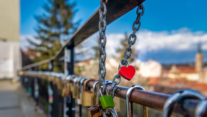 A heart-shaped padlock locked on the fence