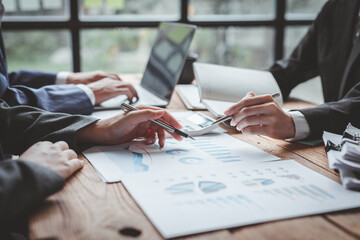 Business people advisors talk, planning analyze investment and marketing on a tablet in the office. Working with graph chart of business Report information. © David