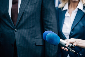 Media interview, a politician at media press conference.