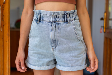 Slim girl in denim shorts