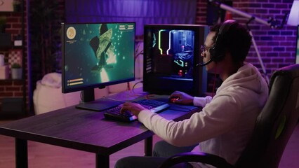 Gamer feeling unhappy after losing difficult level in online space shooter on gaming pc at home. African american man playing internet multiplayer game disappointed after failing competition.