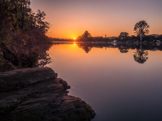 Riverside Sunrise with Reflections