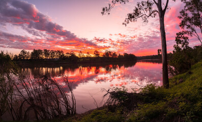 Panoramic Riverside Sunset with Cloud Reflections