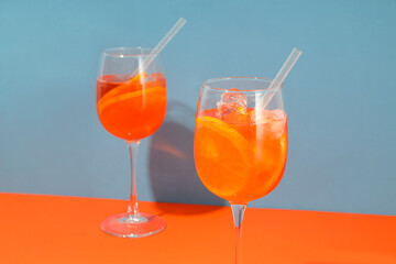 Concept of fresh alcohol drink, Aperol Spritz on two tone background