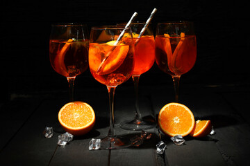 Concept of summer alcohol drink, Aperol Spritz against dark background