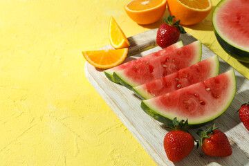 Fresh and juicy fruits on yellow textured background