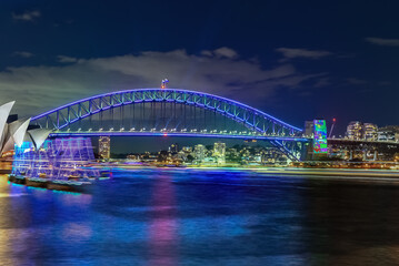Plakat Colourful Light show at night on Sydney Harbour NSW Australia. The bridge illuminated with lasers and neon coloured lights. Sydney laser light show