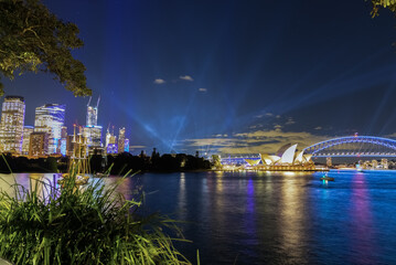 Colourful Light show at night on Sydney Harbour NSW Australia. The bridge illuminated with lasers...
