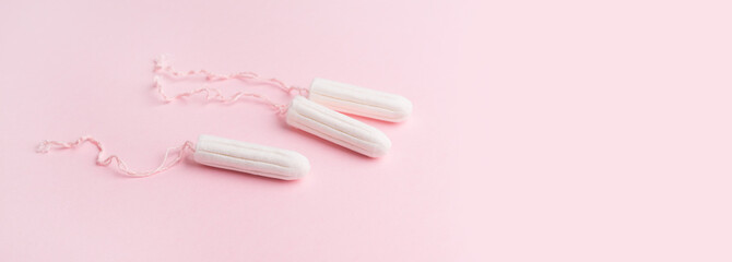 Menstrual tampons on a pink background. Menstruation time. Hygiene and protection for woman. Lack of feminine hygiene products