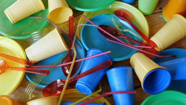 Disposable plastic picnic tableware. Forks plates straw cups