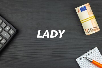 LADY - word (text) and euro money on a wooden background, calculator, pen and notepad. Business concept (copy space).