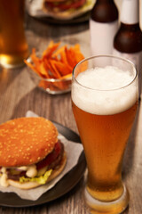 Bottles and glasses of beer with hamburgers