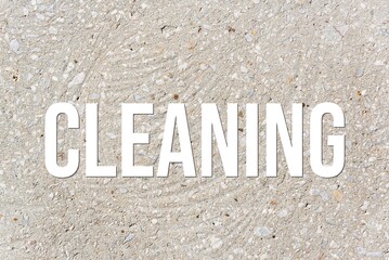 CLEANING - word on concrete background. Cement floor, wall.