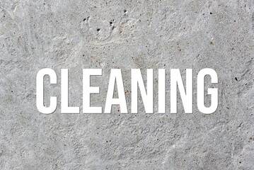 CLEANING - word on concrete background. Cement floor, wall.