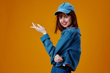 Positive young woman denim clothing fashion posing cap color background unaltered