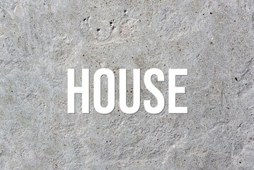 HOUSE - word on concrete background. Cement floor, wall.
