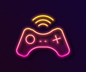 Glowing neon line Wireless gamepad icon isolated on black background. Game controller. Vector