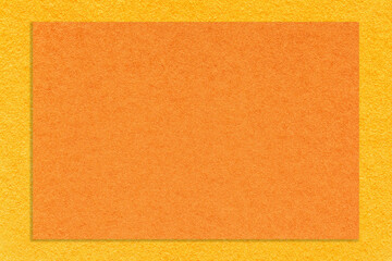 Texture of craft orange color paper background with yellow border, macro. Structure of vintage cardboard