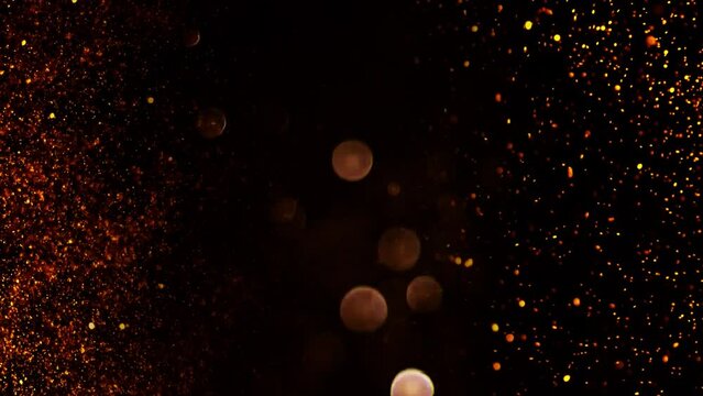 Gold ink in water shooting with high speed camera. Gold glitter background with sparkle shine light confetti. Super Slow Motion at 1000fps. effect. blue glitter