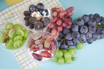 yoghurt in clear cup,topping with fresh grape,