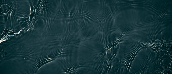 Black transparent clear calm water surface texture with ripples, splashes. Abstract nature banner...