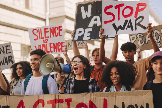 Multicultural teenage activists protesting against war and violence