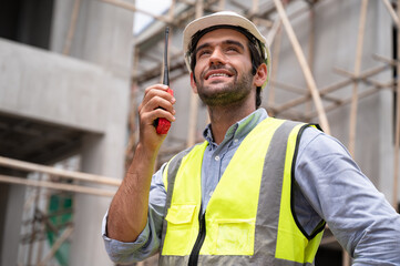 Mechanical Engineer caucasian Working with walkie talkie on construction home building site	