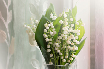Lilies of the valley bouquet. The floral background is delicate.