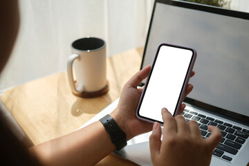 Close up view woman holding smart phone with empty screen for your text message or information content..