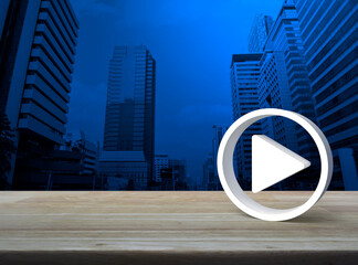 Play button 3d icon on wooden table over modern office city tower and skyscraper, Business music online concept