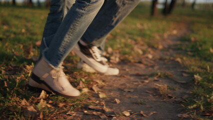 Parents kid leg walking autumn park field together closeup. Outdoor leisure time
