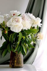bouquet of white peonies in the white table