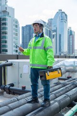 Engineer under checking the industry chilled water fan coil unit air conditioner is water cooling tower air chiller HVAC system of large industrial building to control air system