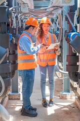 Engineer under checking the industry chilled water fan coil unit air conditioner is water cooling tower air chiller HVAC system of large industrial building to control air system
