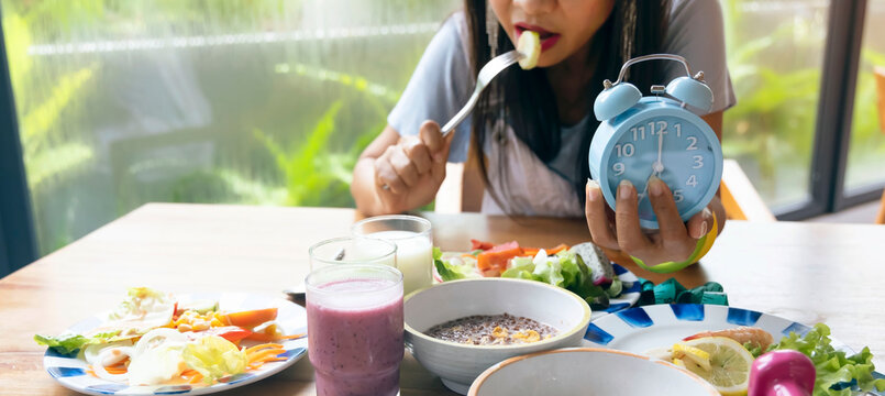 Woman Hand With Blue Cock Which She Is A Diet Time For Intermittent Fasting Icon, IF, Fat Burn, Growth Hormone-diet Concept