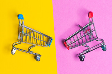 Sale Concepts. Two Empty Trolley Design Shopping or Sale Carts Placed Over Mixed Trendy Yellow and...