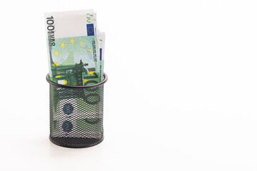 Finances and Savings Concepts. Stack of Money Banknotes in Euro Currency Placed in in Basket Against White Background