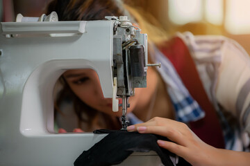 Sewing process of the leather belt. WoMan's hands behind sewing. Leather workshop.