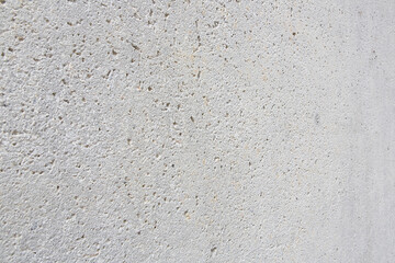 New exposed concrete wall with holes left by the evaporation of the mixing water