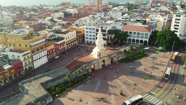 Cartagena, Colombia: Aerial drone footage with a tilt down motion of the Torre del Reloj and city wall in Cartagena colonial old town and the Plaza de los coches in Colombia, South America