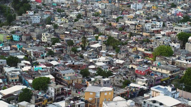 Refugees from Haiti in the dilapidated houses of the dirty quarter of Santo Domingo. Rusty roofs of poor dwellings, aerial view. Life in the slums of the Dominican Republic. social injustice.