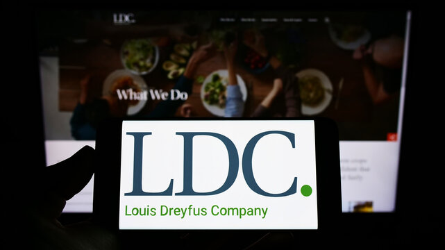 Stuttgart, Germany - 06-12-2022: Person holding smartphone with logo of Louis Dreyfus Company B.V. (LDC) on screen in front of website. Focus on phone display.