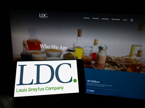 Stuttgart, Germany - 06-12-2022: Person holding mobile phone with logo of Louis Dreyfus Company B.V. (LDC) on screen in front of business web page. Focus on phone display.