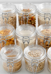 food storage, culinary and storage concept - jars with different cereals or groceries on table
