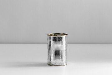 food, eating and preserve concept - close up of tin can with preserve on table