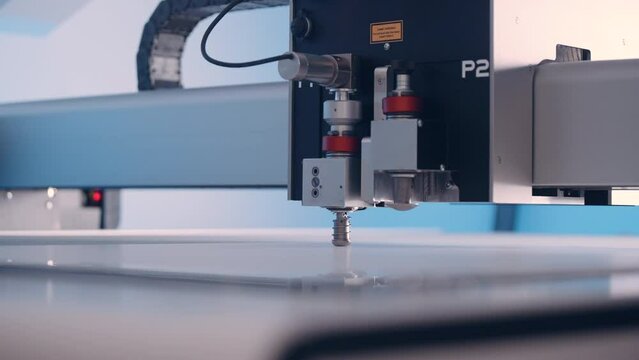 Close-up, cutting machine cuts paper in a printing house.
