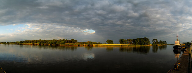 panorama of the river Hunte in Elsfleth, Germany under vivid grey clouds